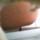 A woman is observed taking a shit into a toilet and then wiping herself from a hole-in-the-wall perspective. Presented in 720P HD. About a minute.